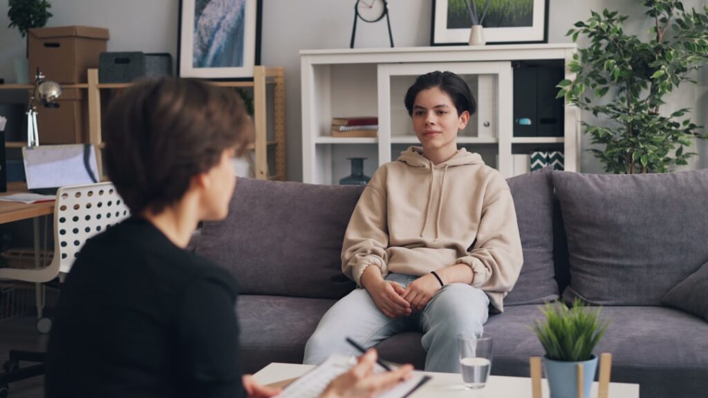Two people talking at a kitchen table, both calmly listening and expressing themselves.